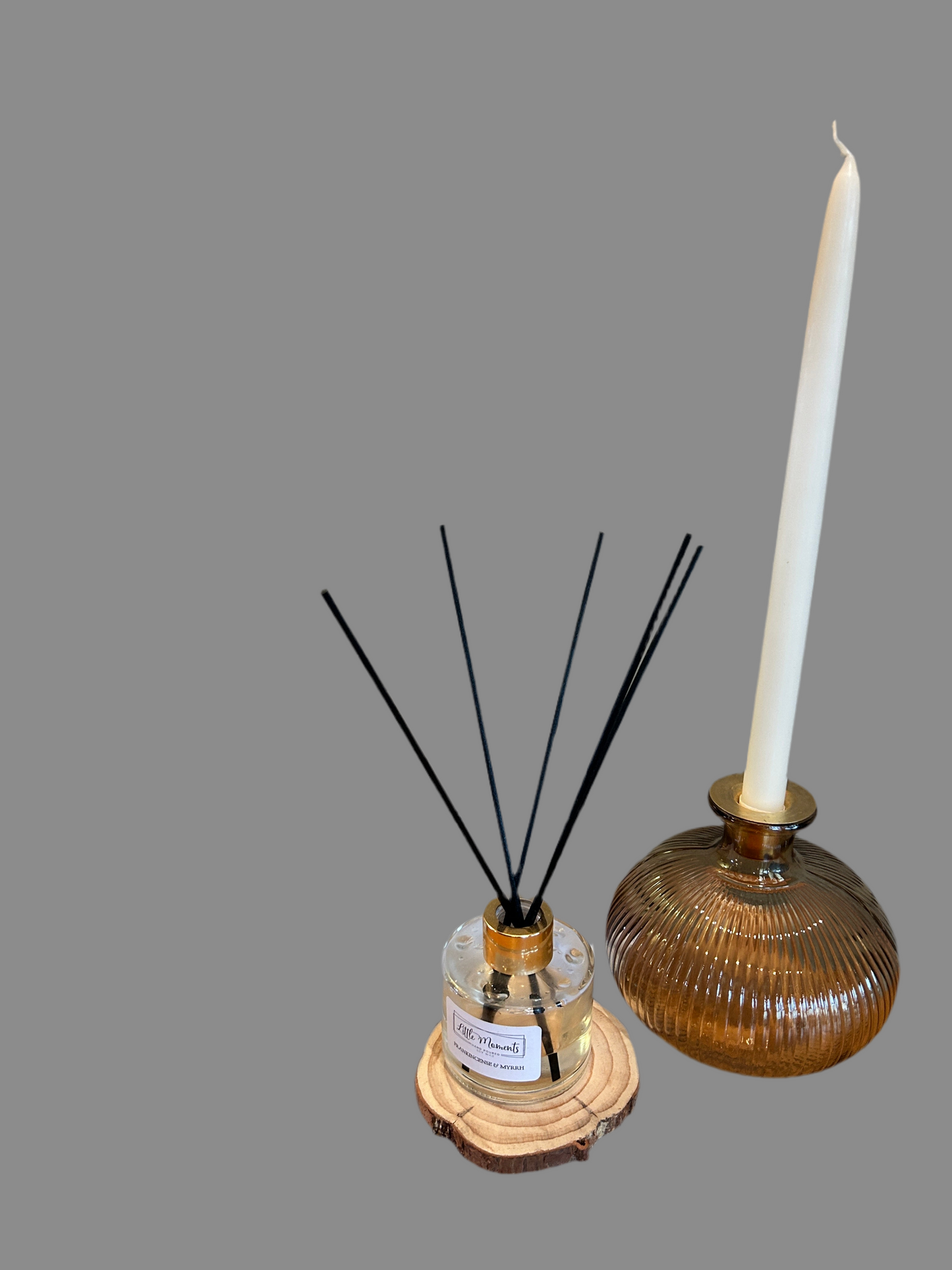 bronze ribbed vase with white candle, and reed defuser 