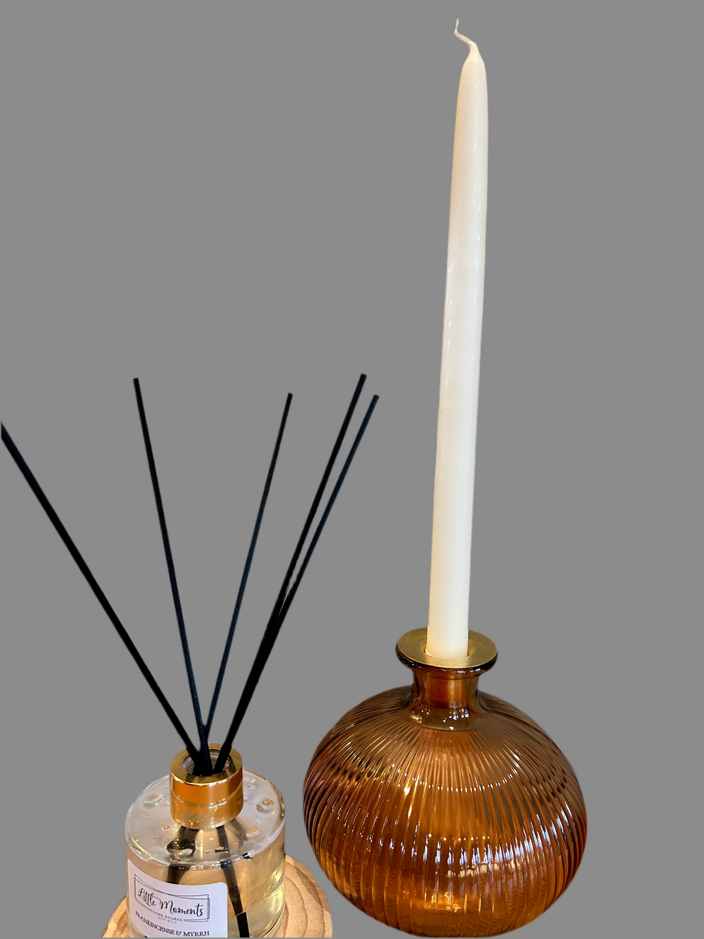 bronze ribbed vase with white candle, and reed defuser 