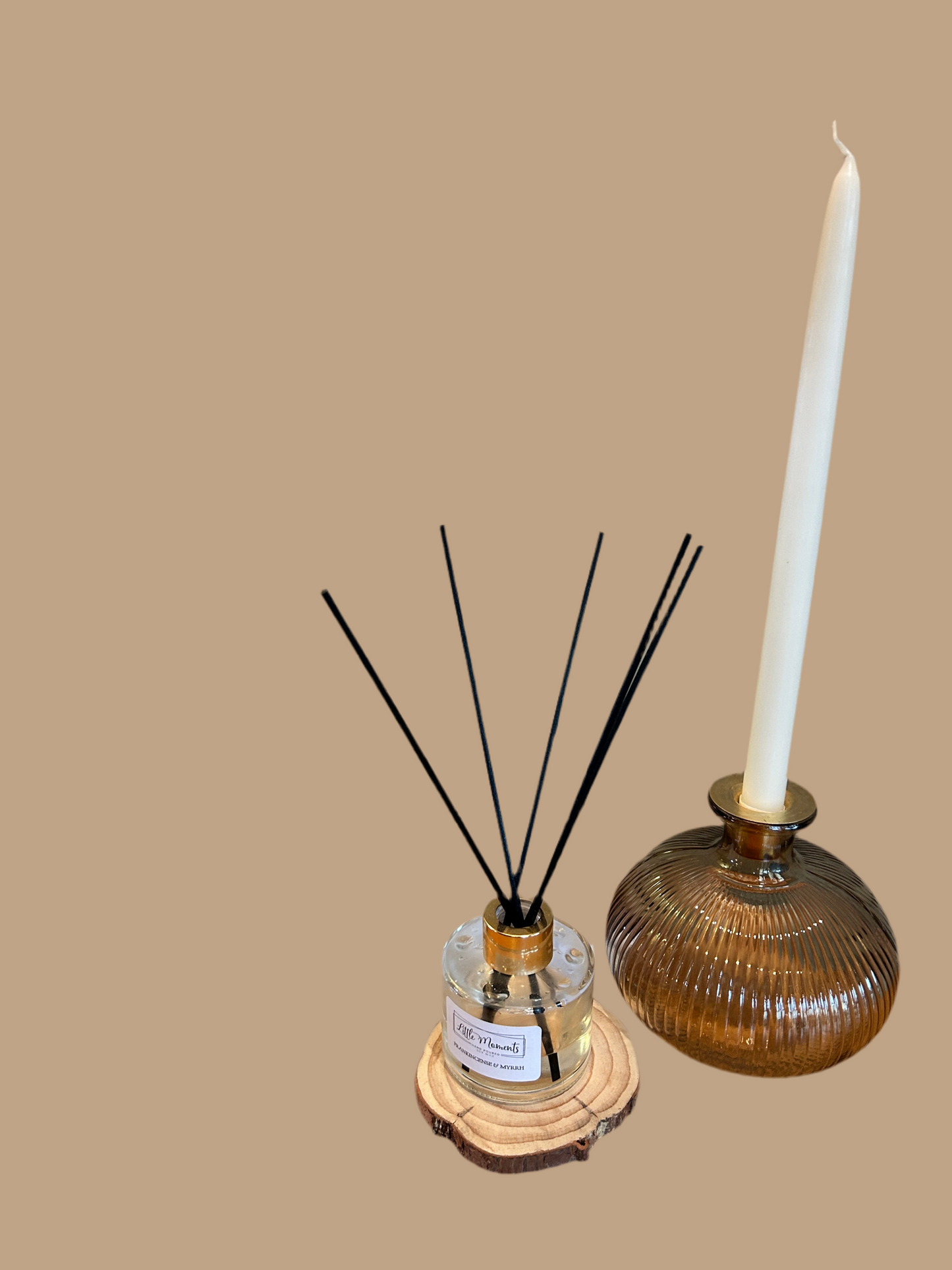 black  ribbed vase with white candle, and reed defuser 